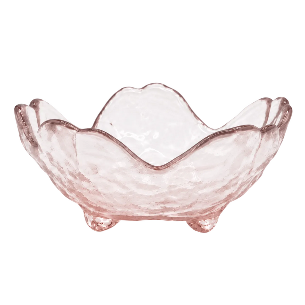 A pink glass candle holder with a scalloped, wavy rim and small feet, featuring a textured hammered finish, shown on a white background.