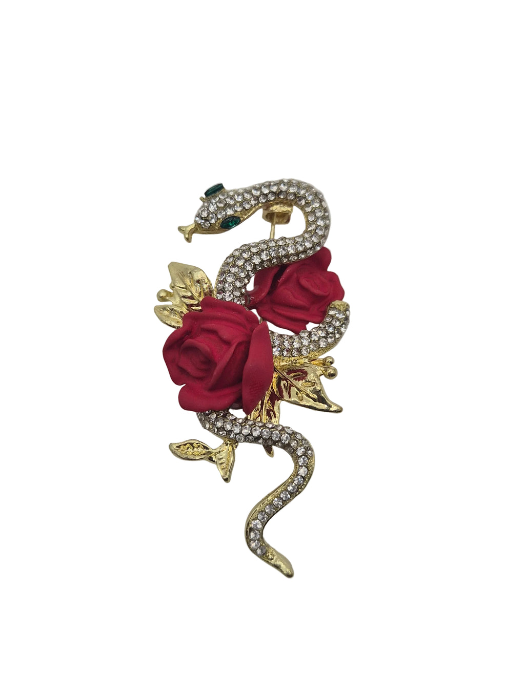 A gold metal snake and rose brooch featuring red roses, gold leaves, and clear rhinestones on a white background.