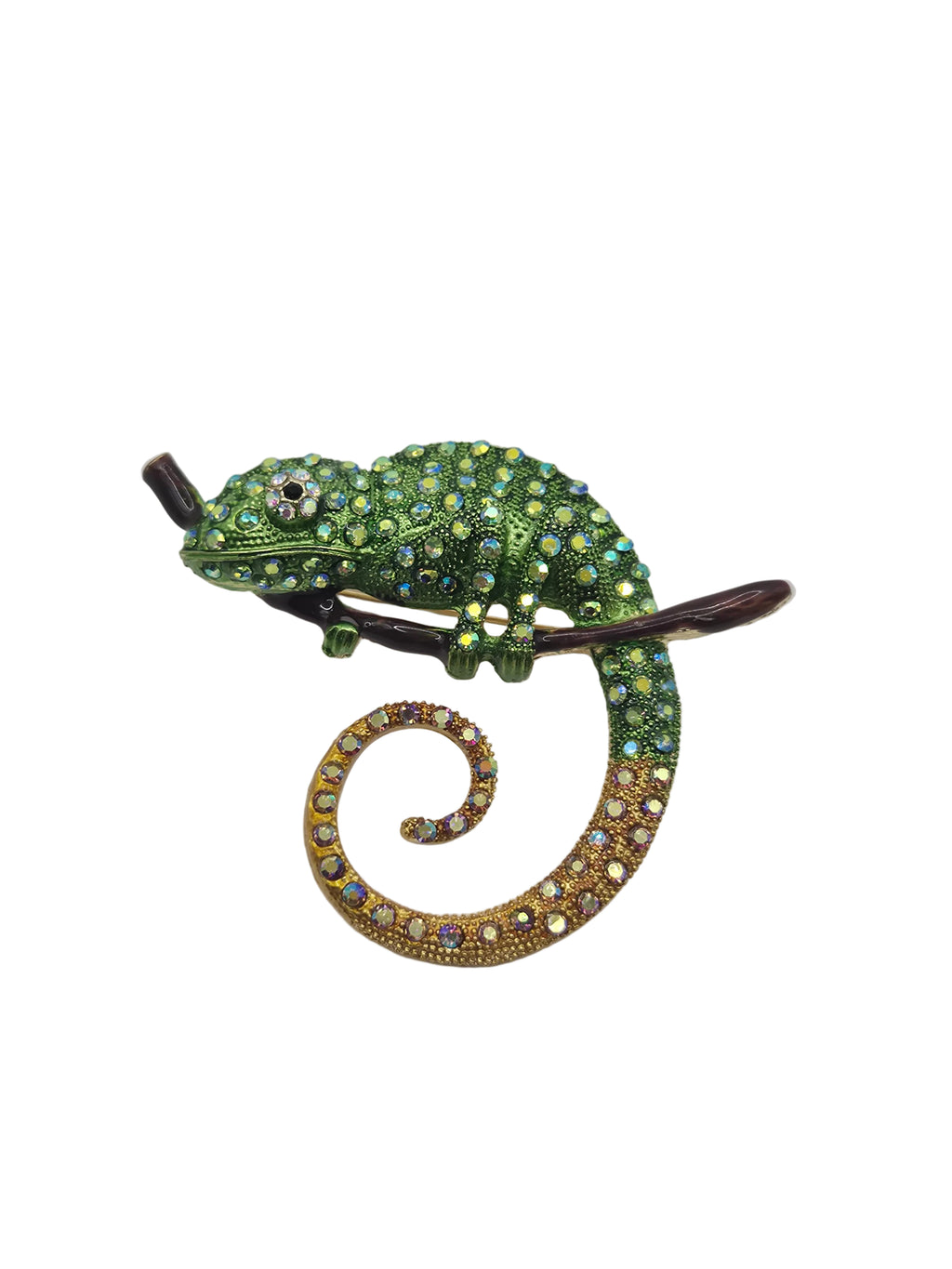 A decorative lizard or chameleon-shaped brooch embellished with green rhinestones and a curled tail paved with gold and iridescent rhinestones, shown on a plain white background.