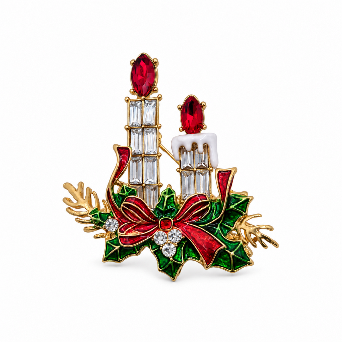 A gold-tone Christmas candle brooch featuring two lit candles with red wax and clear crystal details, surrounded by green holly leaves, a red bow, and small clear rhinestones, set against a plain white background.