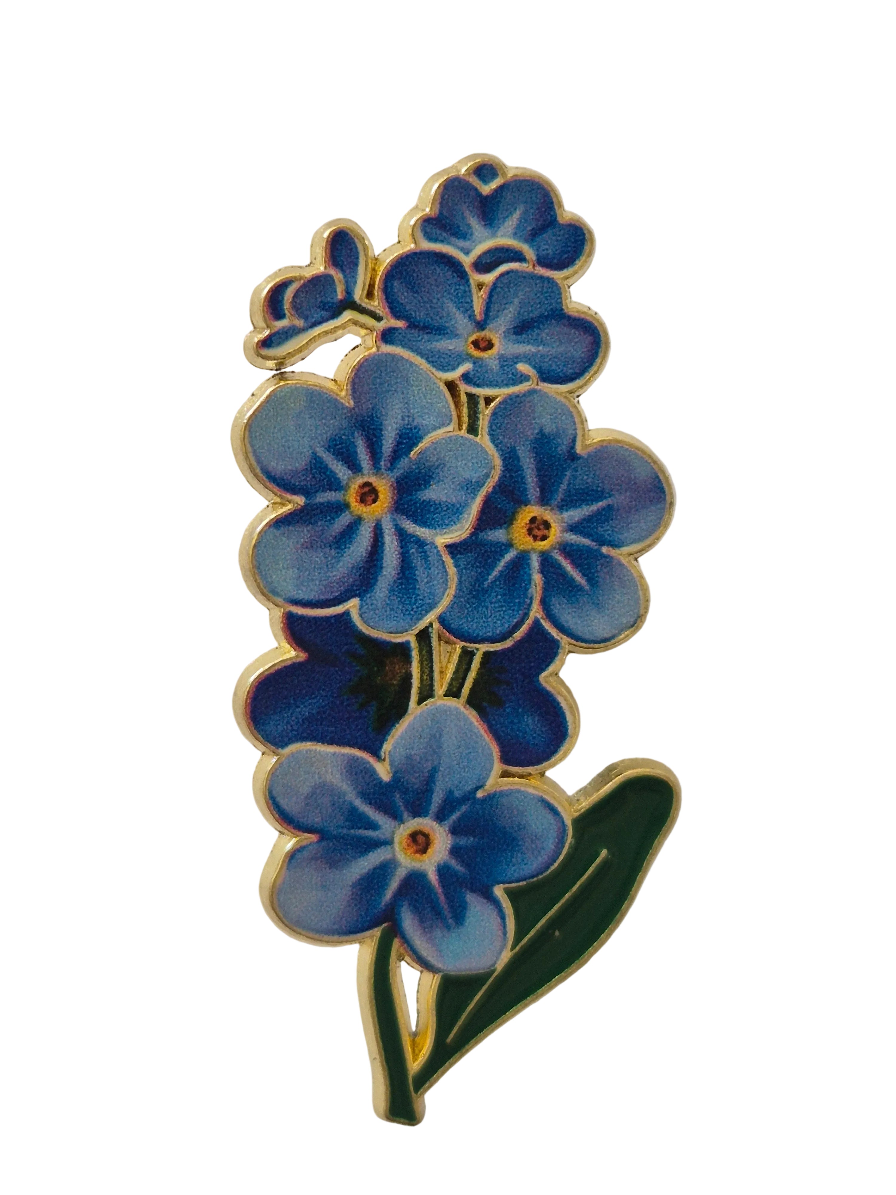 Blue floral design brooch on a white background