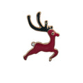 A festive enamel lapel pin shaped like a leaping red reindeer with black antlers and gold-tone metal outlines, isolated on a white background.