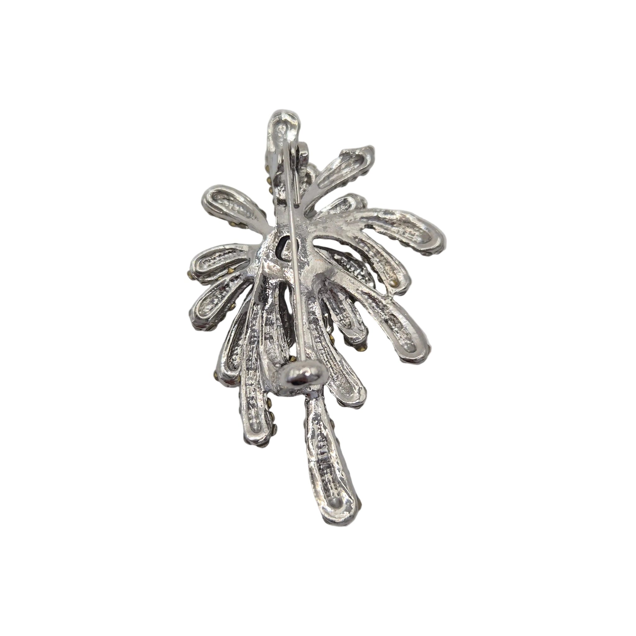 Silver firework brooch pin shown on reverse side, displayed against a plain white background.