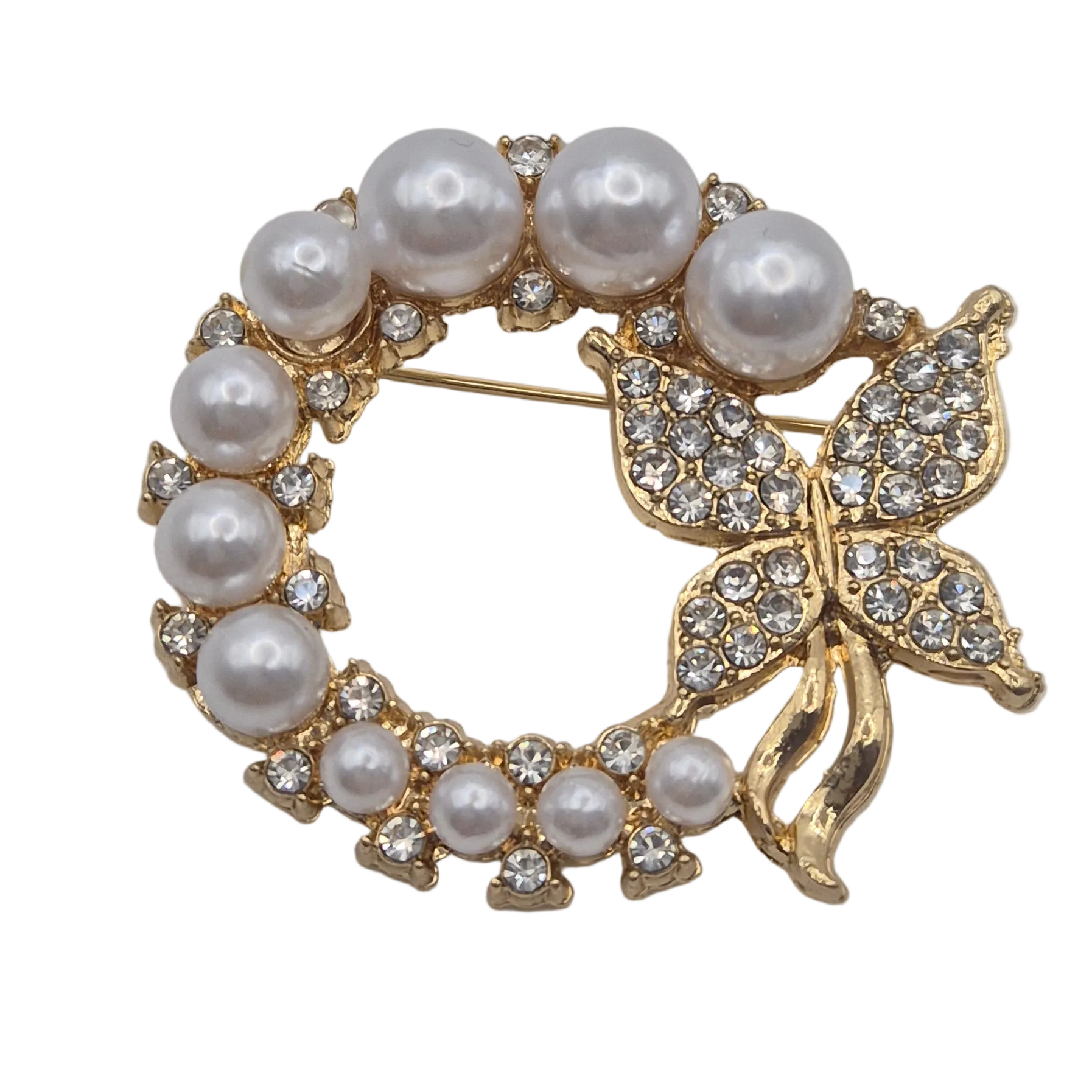 Gold wreath design brooch with sparkling butterfly detail and faux pearls, set against plain white background.