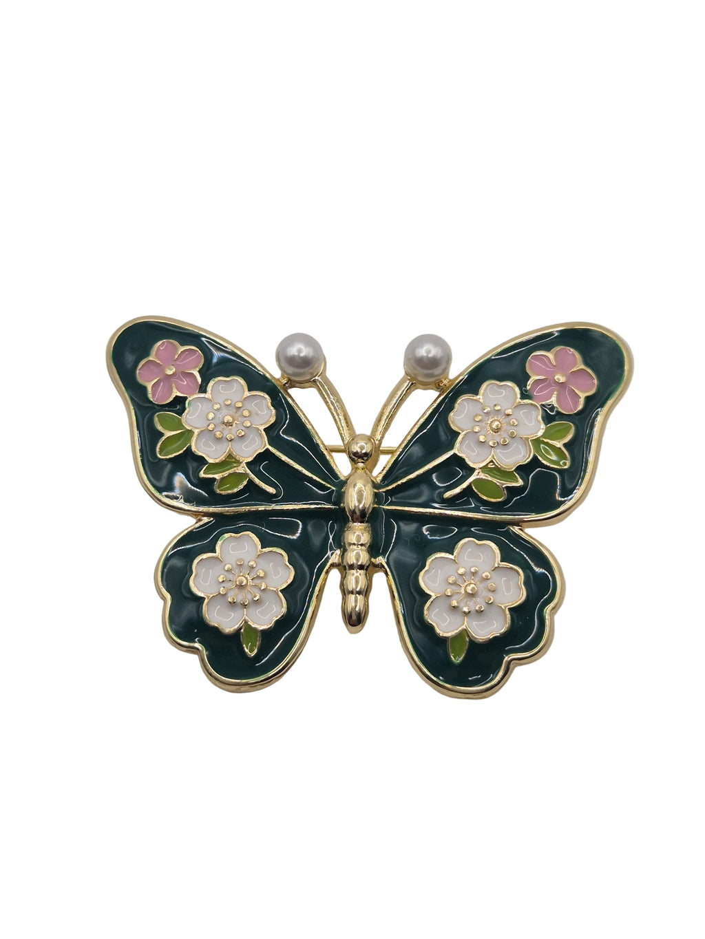 Butterfly-shaped brooch with floral details on a white background