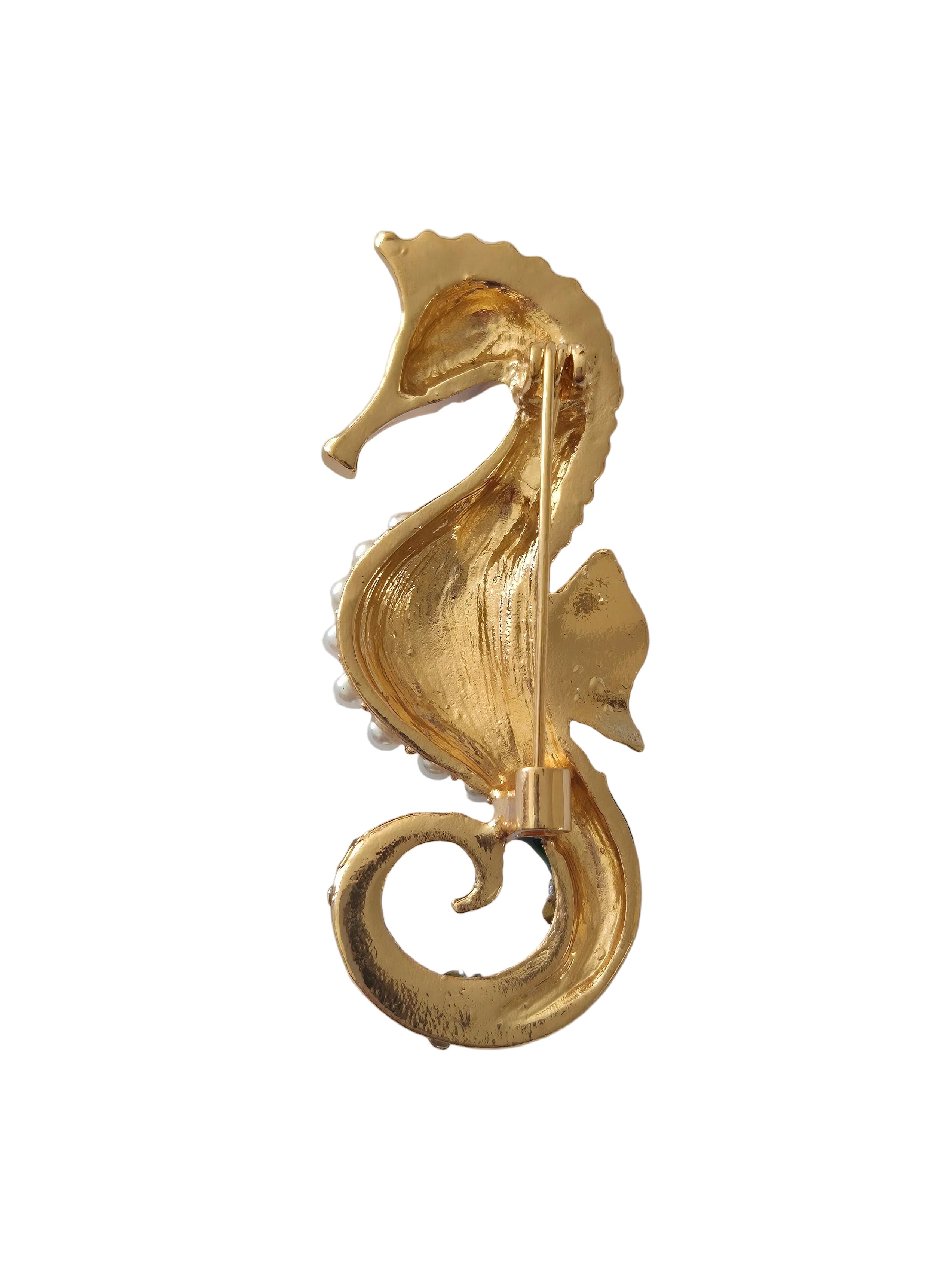 Gold decorative seahorse brooch
 on a gray background