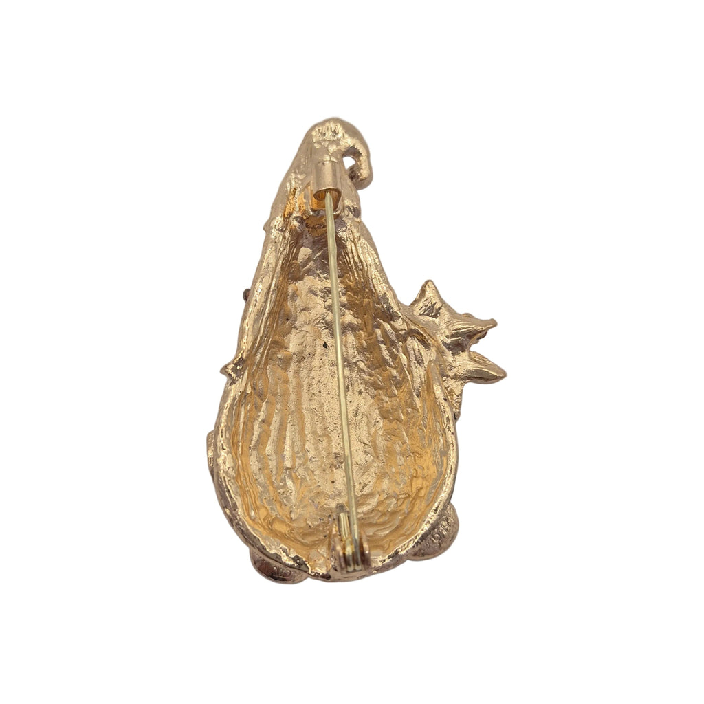 A gold-toned textured enamel pin shaped like a gnome, photographed from the back against a plain white background.