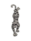 Silver tiger brooch with gemstones on a white background