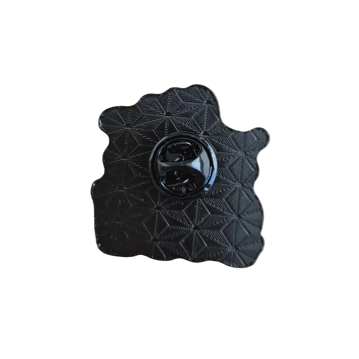 Reverse black side of a festive enamel brooch, shown against a plain white background.
